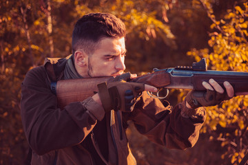 Hunter with shotgun gun on hunt. Autumn hunting season. Autunm hunting. Hunting without borders....