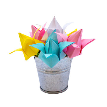 Photo of many colored paper flowers in the small bucket