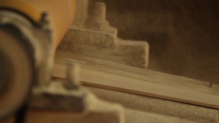 Craftsman Cutting the Wood in his Workshop. The Dust Flies in the Air. Close-Up. Full HD. 