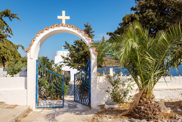 Gate of a Greek church on a sunny summer day. Serifos island, Greece © vivoo