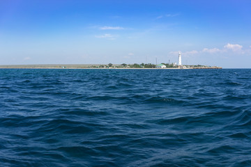 Obraz premium Marine landscape with views of the Cape Tarhankut and the white lighthouse against the sky.
