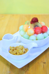 Bingsu dessert on the table, Summer season sweeten, lifestyle menu eat cooling sweet ice with delight delicious bread fruit topping and blended Peach smoothie drink, candy sweet,