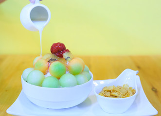 Bingsu dessert on the table, Summer season sweeten, lifestyle menu eat cooling sweet ice with delight delicious bread fruit topping and blended Peach smoothie drink, candy sweet,