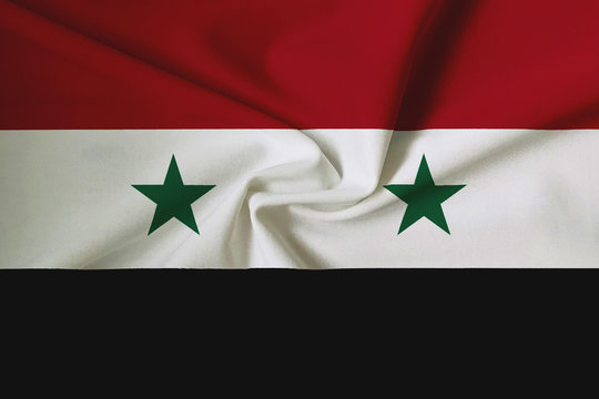 National flag of Syria on a waving cotton texture background