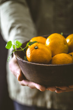 Fresh tangerine in hands