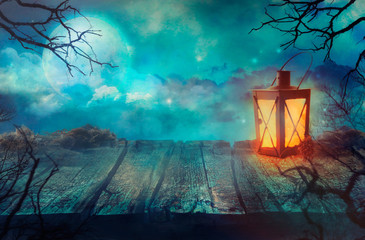 Obraz premium Old Table With Lantern And Full Moon.