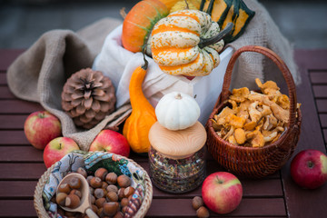 Decoration for halloween with pumpkins, nuts and flowers on the table in autumn