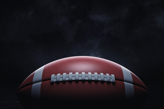 3d rendering of a leather ball for American football lying with its seams in focus on a dark background.