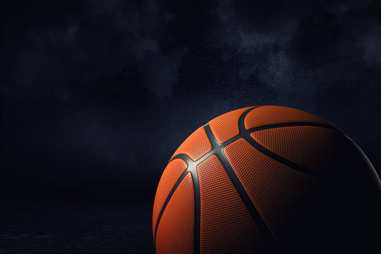 3d rendering of an orange basketball ball shown in close view in high definition on a dark background.