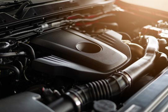 closeup detail of car engine with soft-focus and over light in the background