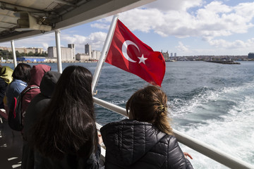 The flag scene from Turkey. The Turkish flag is fluctuating in the ferry on the sea.