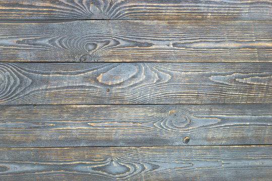Background of wooden texture boards with remnants of gray paint. Horizontal.