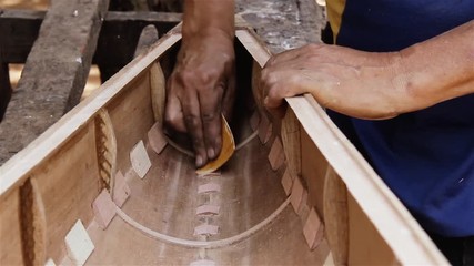 Artisan Sanding the Wood. Manufacture of a Musical Instrument.