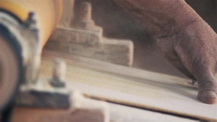 Craftsman Cutting the Wood in his Workshop. The Dust Flies in the Air. Close-Up. Full HD. 
