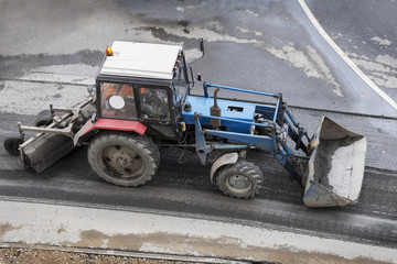 Wheeled tractor during road construction working. High angle view. Road renewal process