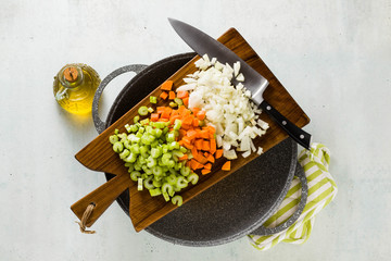 chopped vegetables and a chef's knife on a wooden cutting board. Basic cutting for restaurants or home cooking. and wok