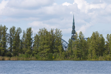 Behind the trees in city.