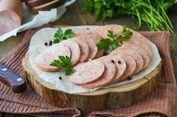 Sliced chicken sausage on a wooden board     