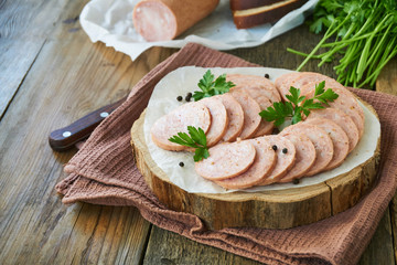 Sliced chicken sausage on a wooden board     