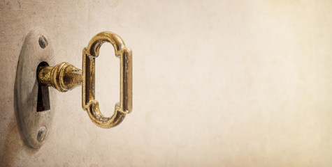 Old key in keyhole, macro shot. Retro style. Concept and Idea for History, business, security...