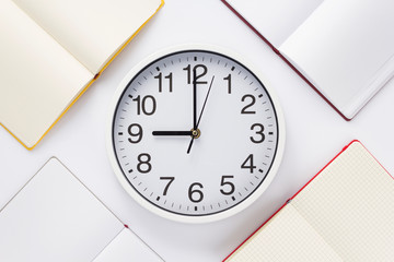 open notebook or book with wall clock