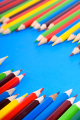 Colored pencils background.Color pencils on blue background.Close up. Many different colored pencils on blue background.Colorful pencil .Colorfull