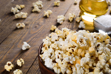   Prepared popcorn in frying pan, corn seeds in bowl and corncobs on kitchen table.Air salty popcorn. Salt popcorn on the wooden background . Chees .Popcorn texture