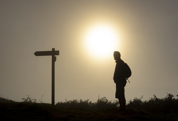 Hiking man in the mountains with backpack,  the Camino de Santiago in Spain, Way of St James