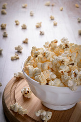 Salt popcorn on the wooden table, selective focus