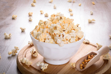 Salt popcorn on the wooden table, selective focus