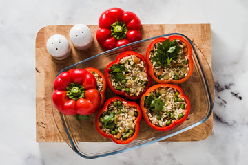 Stuffed peppers in a glass baking dish, ready for baking in the oven. healthy vegan cuisine for the whole family. comfort food