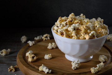 Air salty popcorn.A bowl of popcorn on a wooden table. Rustic style.