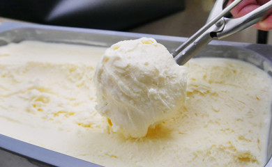 ice cream scoop, scooped out of a container with a utensil,Vanilla