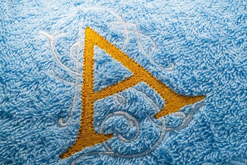 Close up of embroidery alphabet design on towel