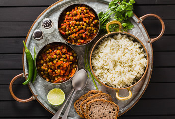vegan curry with green peas and basmati rice served on a wooden table tray, healthy Indian comfort food