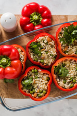 Stuffed peppers in a glass baking dish, ready for baking in the oven. healthy vegan cuisine for the whole family. comfort food