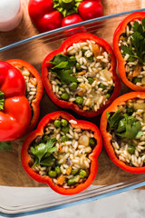 Stuffed peppers in a glass baking dish, ready for baking in the oven. healthy vegan cuisine for the whole family. comfort food