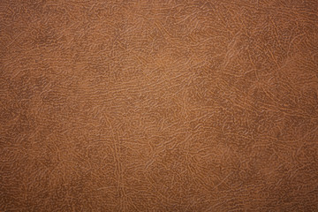 Brown or orange textured leather background. Abstract leather texture.