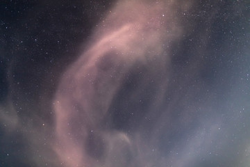 Fototapeta na wymiar Night starry sky visible through the cloud