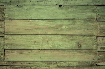 green wooden texture of thin boards on the wall of the fence