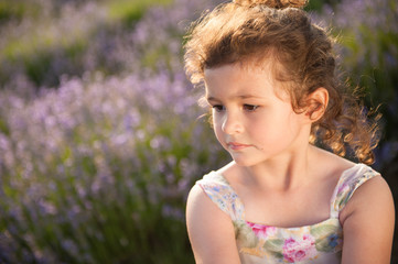 portrait of pretty little caucasian girl with clean skin outdoors summer field