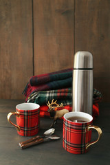 Mugs with hot tea and thermos