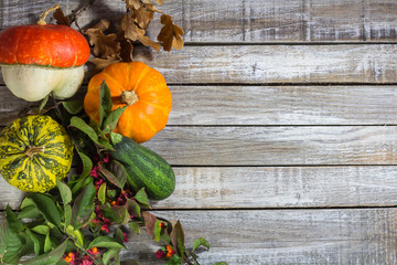Decorative pumpkin with brier, acorn on wood desk