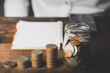 Financial Accounting Concepts with Businessman saving money and coin stacks