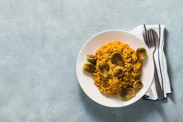 risotto with pumpkin and brussels sprouts on the table. A healthy recipe for the whole family. festive table. copy space