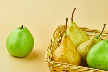 Tasty and fresh pears in wooden basket