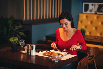 Young woman on breakfast in a restaurant
