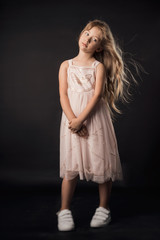 the child in the Studio posing in fashionable clothes