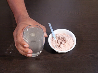 Black Salt Drink for Healthy Body, Black Salt in White Bowl and Black Salt Water on Wooden Background, Healthy Drink for Health