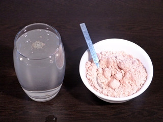Black Salt Drink for Healthy Body, Black Salt in White Bowl and Black Salt Water on Wooden...